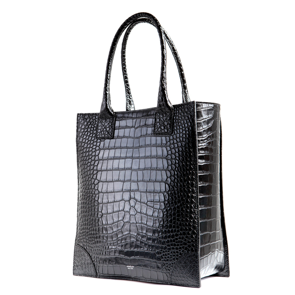 Black Shopper Tote bag in croc-embossed leather. Long handles to carry in the crook of the elbow or conveniently over the shoulder. Spacious for your essentials to wear as a work bag and elevate your business casual wear. 