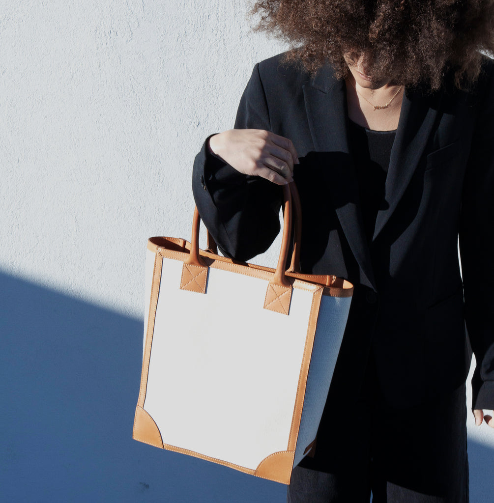 Model wears the Duke Shopper Tote Bag in Canvas and leather trim.  Lined with tan suede leather and internal pockets to help organize keys, wallet and phone.